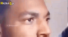 a close up of a man 's face with the words hazrat gif written on the bottom .