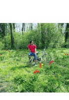 a man in a red shirt sits on a bike