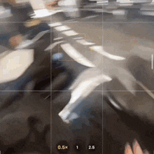 a blurry photo of a person 's feet with the number 0.5x on the bottom left