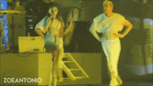 a man and a woman are dancing on a stage and the words zoeantonio are on the bottom right