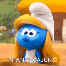 a cartoon smurf says thanks cajun with a smiling face