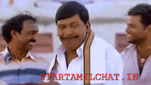a man with a mustache is smiling in front of two other men with the words starttamilchat.in on the bottom