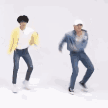 a group of people are dancing in a room .
