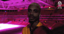 a man is smiling in front of a purple background with the youtube logo