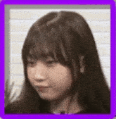 a close up of a woman 's face in a purple frame