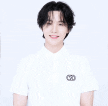 a girl with long brown hair is wearing a white shirt