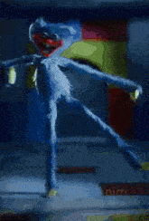 a blue teddy bear is jumping in the air next to a yellow toy man .