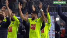 a group of soccer players wearing neon green jerseys with vdk on the front