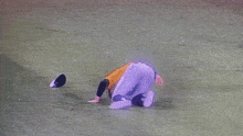 a baseball player is laying on the ground with his head down