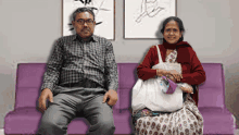 a man and a woman are sitting on a couch