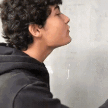 a close up of a person 's face with a hoodie on .