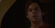 a close up of a man 's face in a dark room