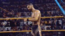 a man in a wrestling ring with # 206live on the bottom