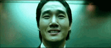 a man in a suit is crying in an elevator .