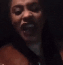 a woman is making a funny face with her mouth open