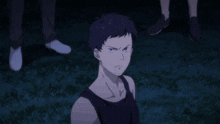 a man with a serious look on his face is standing in the grass