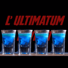 four shot glasses of blue liquid are lined up in front of a sign that says l ultimatum