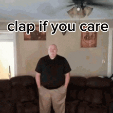 a man standing in front of a couch with his hands in his pockets and the words clap if you care