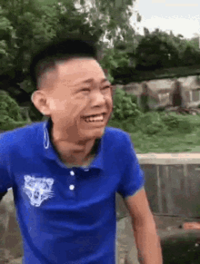 a man in a blue shirt with a tiger on it