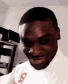 a man in a white shirt is smiling for the camera .