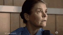 a woman in a police uniform is talking into a microphone with the blacklist written on the bottom