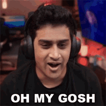 a man wearing headphones is making a funny face and says oh my gosh .