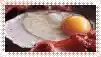 a close up of eggs and bacon on a plate .
