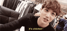 a young man is taking a selfie in a store and saying it 's chicken .