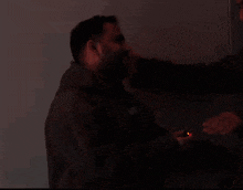 a man with a beard is being punched in the face by another man .