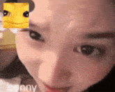 a close up of a woman 's face with a bee on her forehead