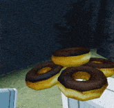a cartoon character is holding a red rose while standing next to a pile of donuts