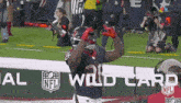a football player celebrates a touchdown in front of an nfl ad