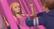 a barbie doll is sitting next to a man on a pink swing .