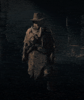 a woman in a red and black costume is standing in the dark