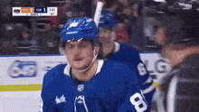 a hockey player with the number 8 on his jersey is standing on the ice