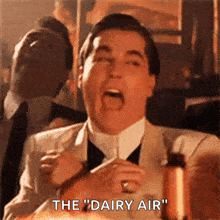 a man in a suit and tie is saying " the " dairy air "