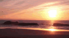 a sunset over a body of water with the sun shining brightly
