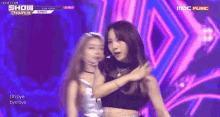 two women are dancing on a stage with the words oh bye bye bye on the bottom