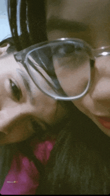 two girls wearing glasses and a pink shirt