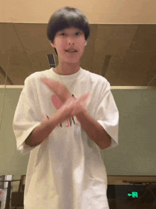a person wearing a white t-shirt that says ' n ' on it
