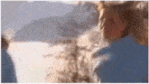 a blurry picture of a man and woman standing next to each other .