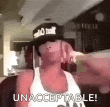 a man wearing a hat and a tank top is making a funny face and says `` unacceptable ! ''