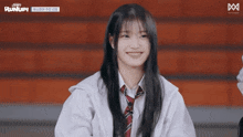 a girl is smiling in front of a sign that says runup on it