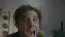 a shirtless man with his mouth wide open is screaming in front of a sign that says shark