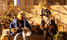 two stuffed birds are sitting on a bench in front of a yellow caution tape