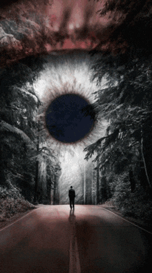 a man is walking down a road with a large eye in the background