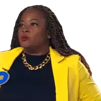 a woman wearing a yellow jacket and gold chain necklace