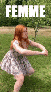 a woman in a dress squatting in the grass with the word femme behind her