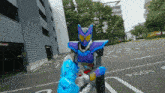 a purple and blue robot is fighting another robot in a parking lot with the number 2024 written on the ground