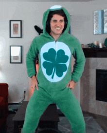 a man is wearing a green outfit with a clover on the front
